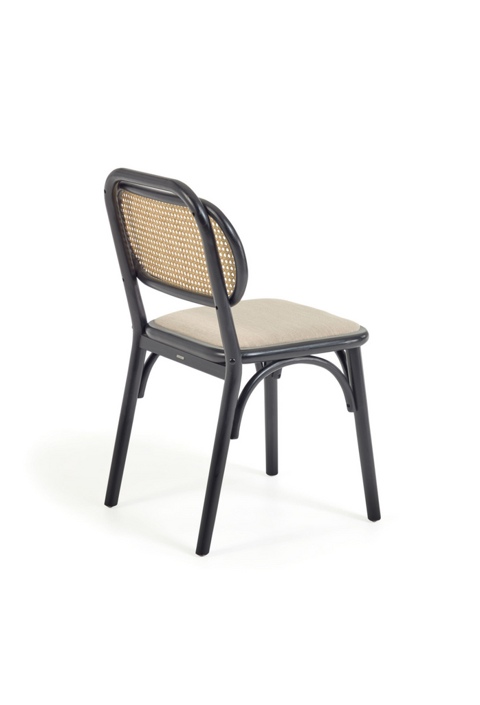 Black wooden chair with back in natural rattan