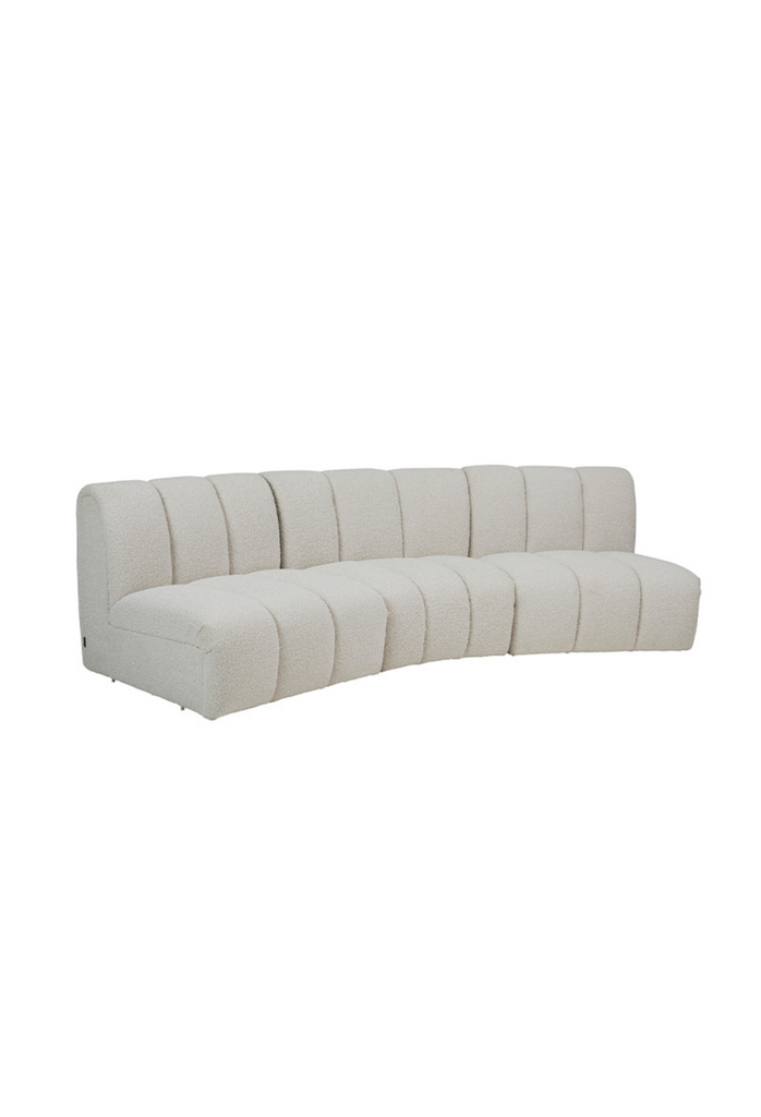 Modular 3 seater sofa with three curved modules fully upholstered in cream boucle feautring stitching details creating a padded look