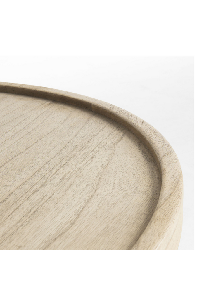 Small round coffee table made of natural wood in a natural light grey wash finish on white background