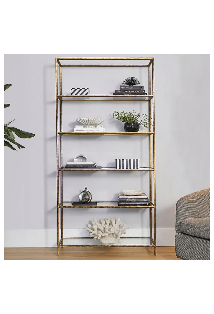 High rectangular book shelf with 5 glass shelves and a solid iron frame with antique brass finish and sharp edges on white background