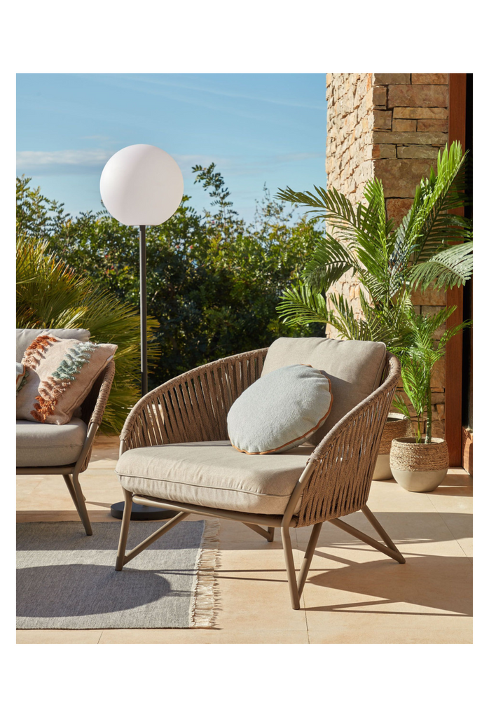 Brown outdoor chair with water resistant cushion.