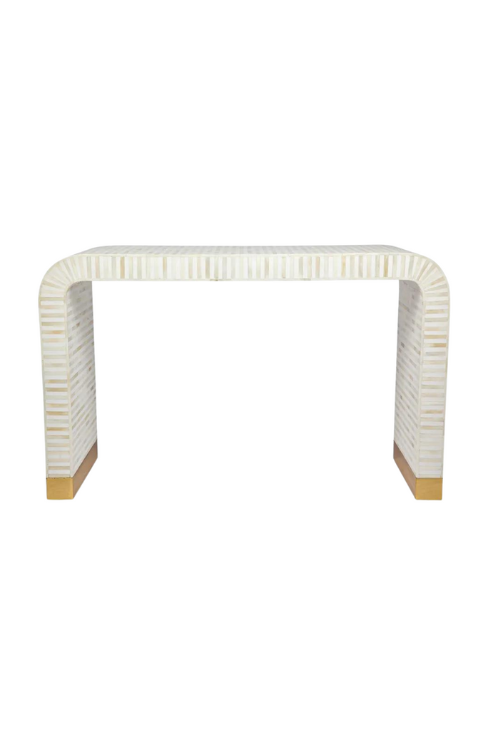 Modern curved console table with white bone inlay creating white and bone striped look and brass clad base