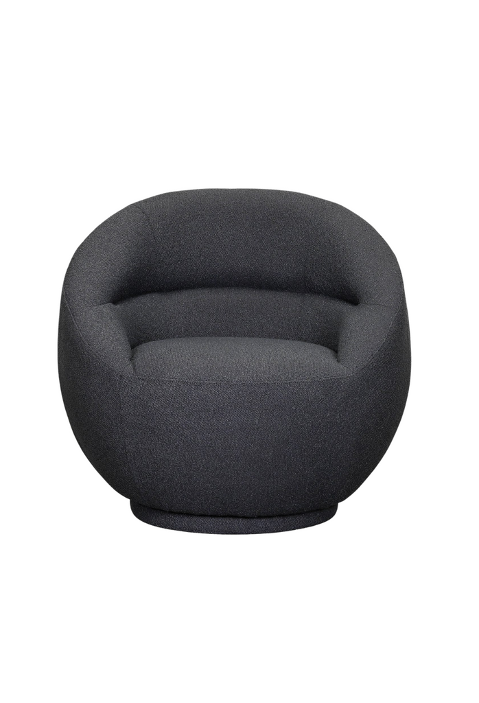 Compact armchair fully upholstered in dark blue fabric with curved seat and back rest on an upholstered base