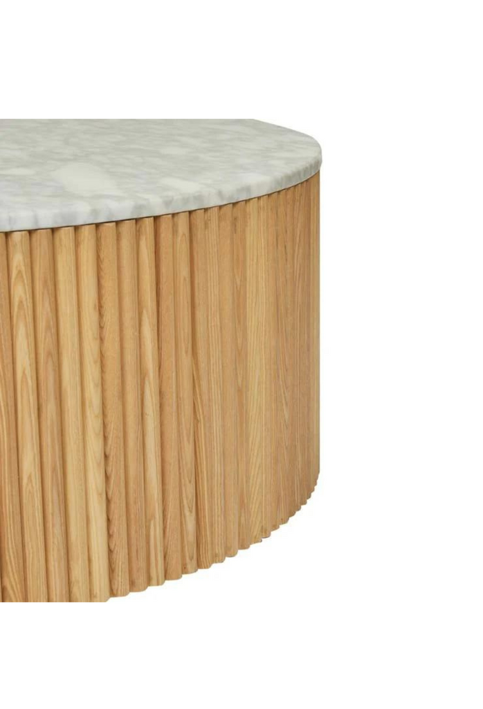 Solid Round Coffee Table with a white marble top and a natural rippled timber outside on a hidden gold metal base