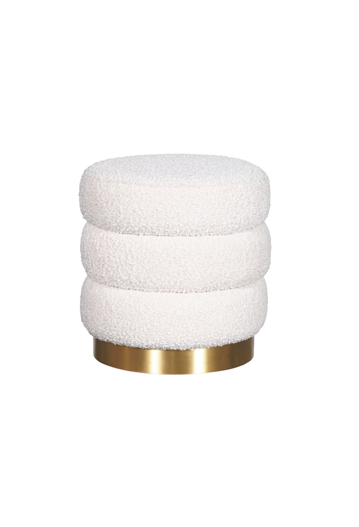 Round ottoman with three layers creating ribbed shape upholstered in ivory boucle with brushed gold base