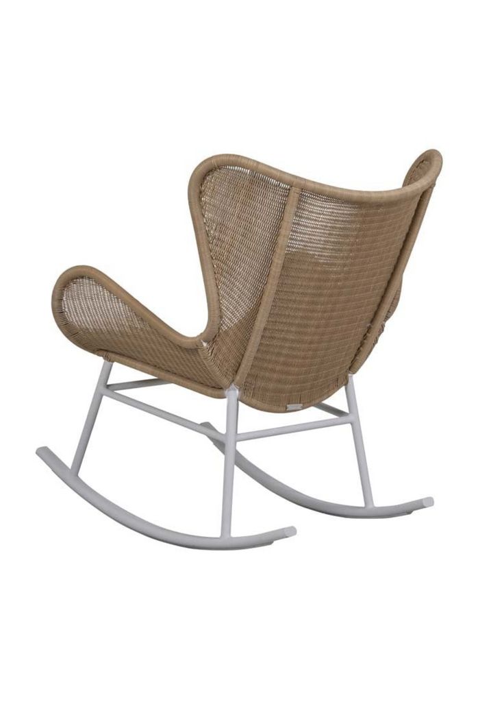 Modern wingback style rocking chair with beige woven ecolene resin seat and white metal base on white background