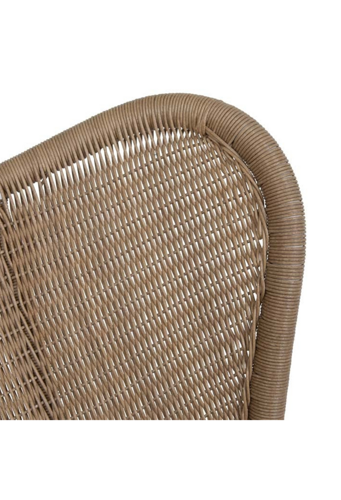 Modern wingback style rocking chair with beige woven ecolene resin seat and white metal base on white background