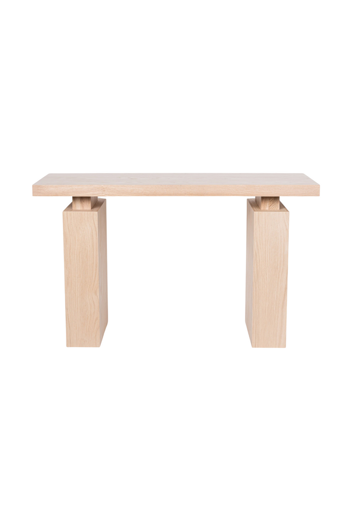 Natural oak console table with rectangular table top and two solid legs both with sharp edges on white background