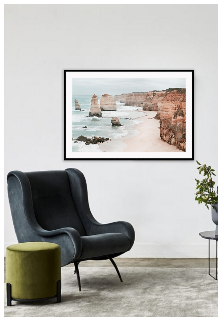 Landscape photography print showing the Twelve Apostles in Victoria, Australia with red rocks and cliffs sorrounded by sand and the ocean.