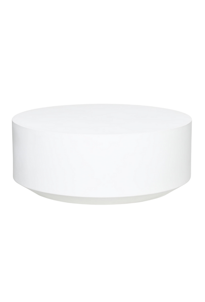 Solid round indoor and outdoor coffee table fully painted in white on a white background