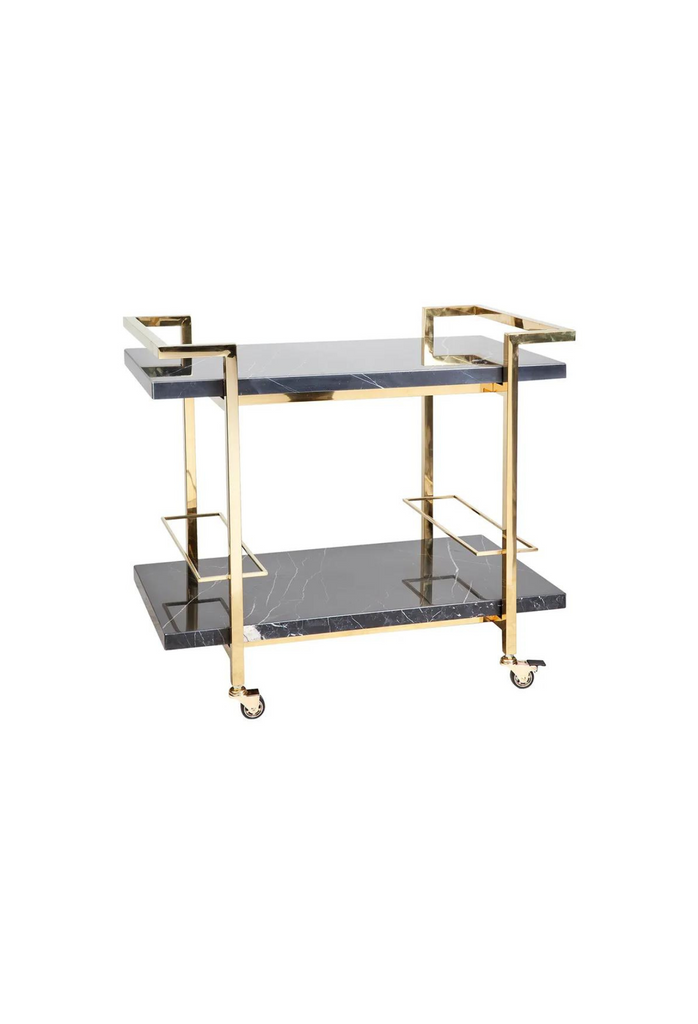 Drinks trolley with two rectangular black marble shelves in a geometric shaped gold steel frame with sharp edges on white background