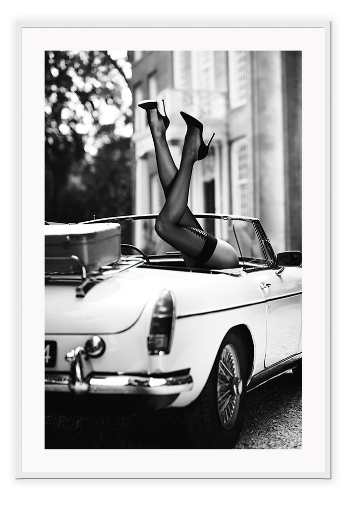 Fashion photography with womans legs coming out of a vintage car black and white lingerie sexy  