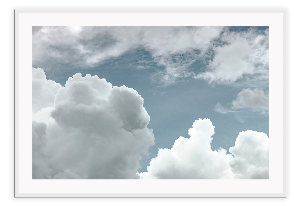 White fluffy cloud sky print with blue background, minimal style 