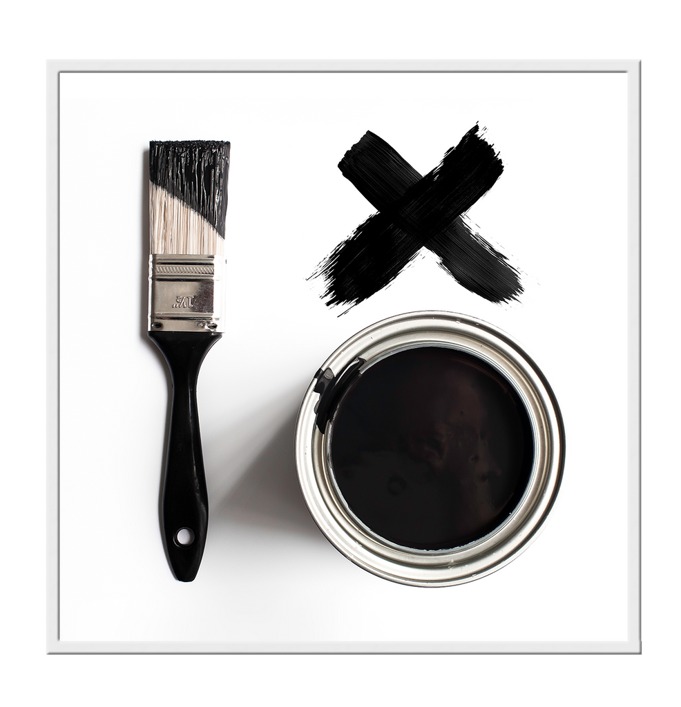 Scandi photography black and white image of white background, paint brush, can and black letter x. 