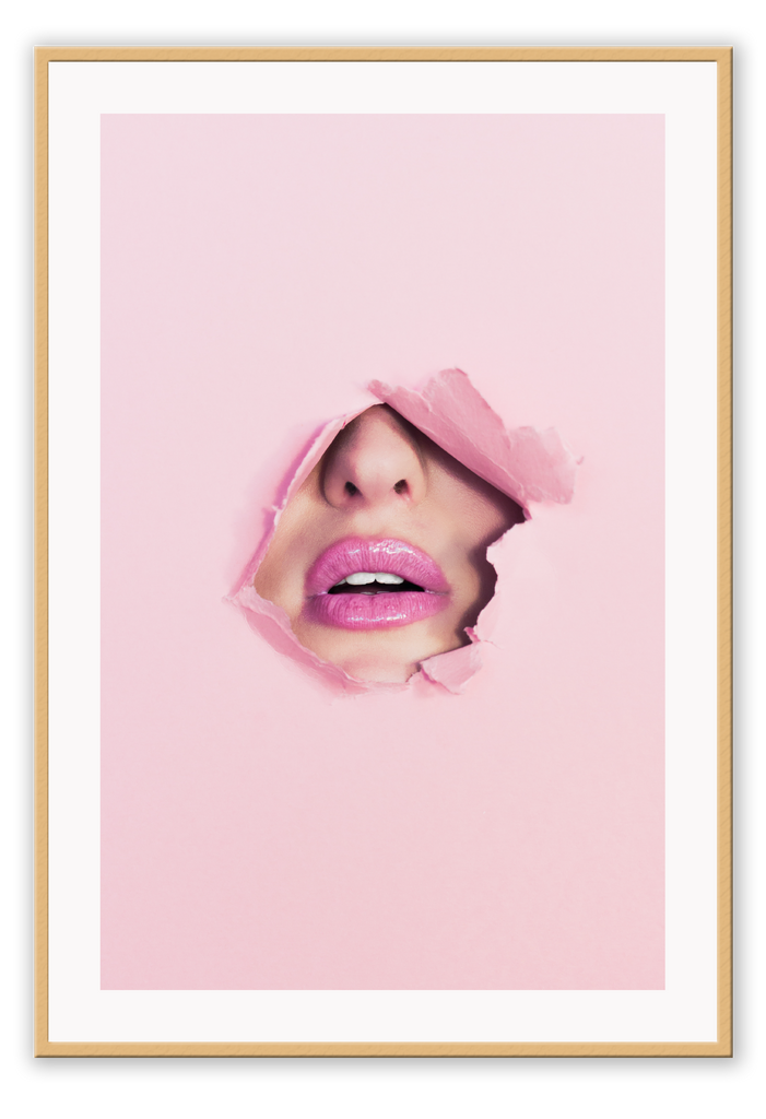 A pink wall art with fashion model face and pink lips. 