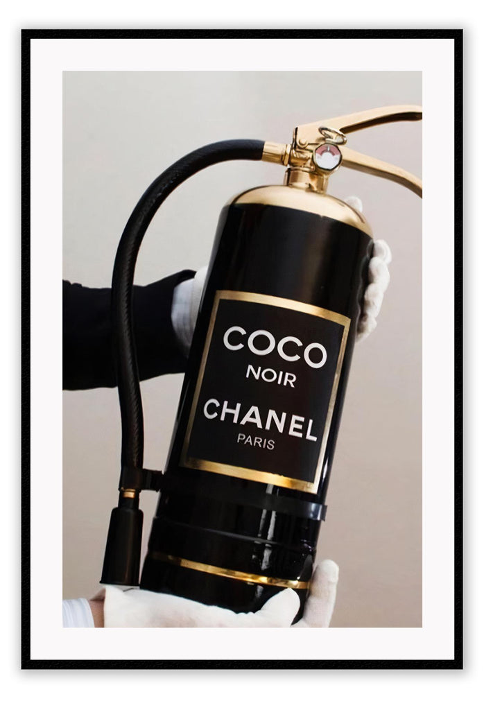 Gold, black and white fire fashion extinguisher with Chanel logo and hand with glove holding