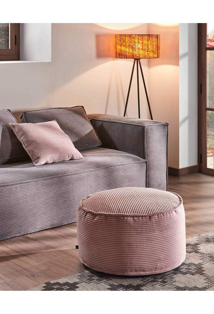 Modern Round Pouf with Soft Dusty Pink Corduroy Upholstery and Piping on a White Background