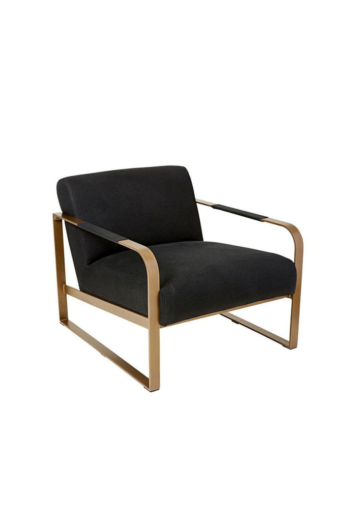 Black linen occassional armchair with brushed brass finish frame and curved arm rests on a white background