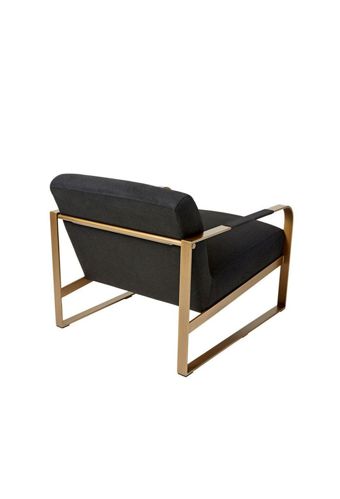 Black linen occassional armchair with brushed brass finish frame and curved arm rests on a white background