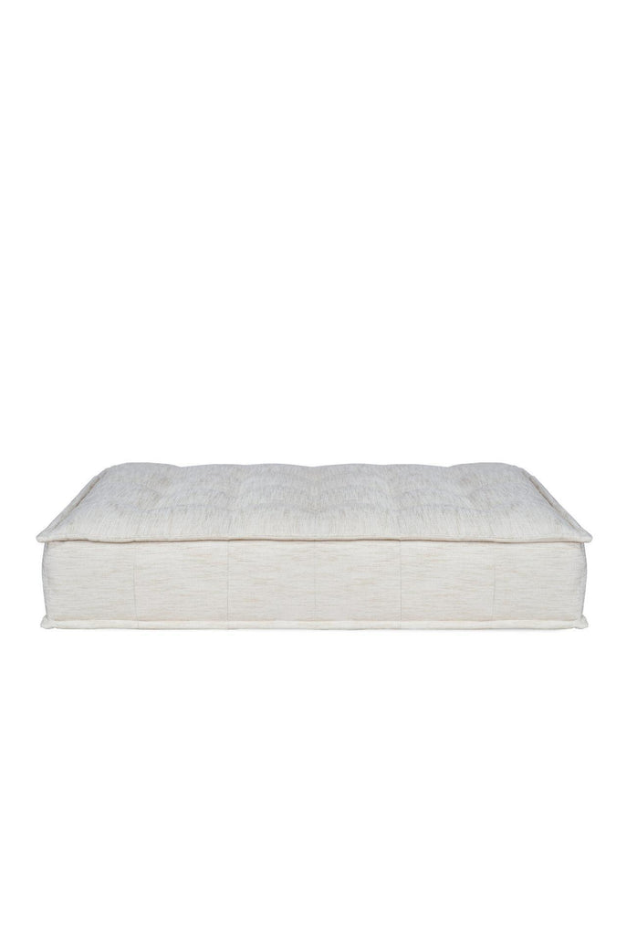 Rectangular Double lounger with button tufting fully upholstered in a natural off-white fabric with matching cushion on a white background