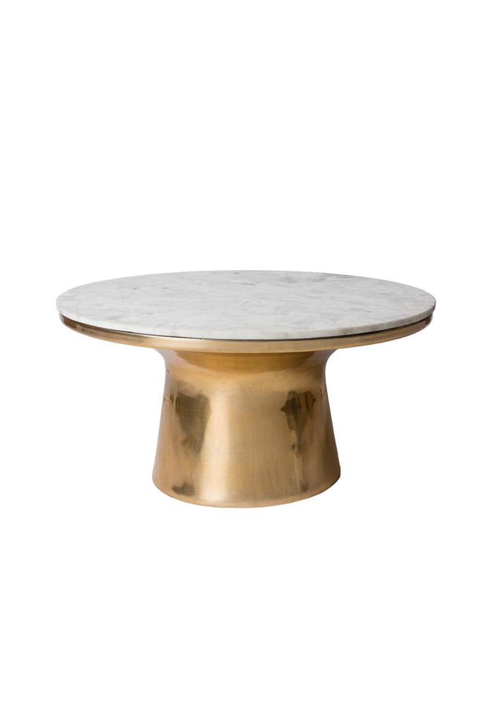 Large round coffee table with a brass drum base and a white marble top on white background