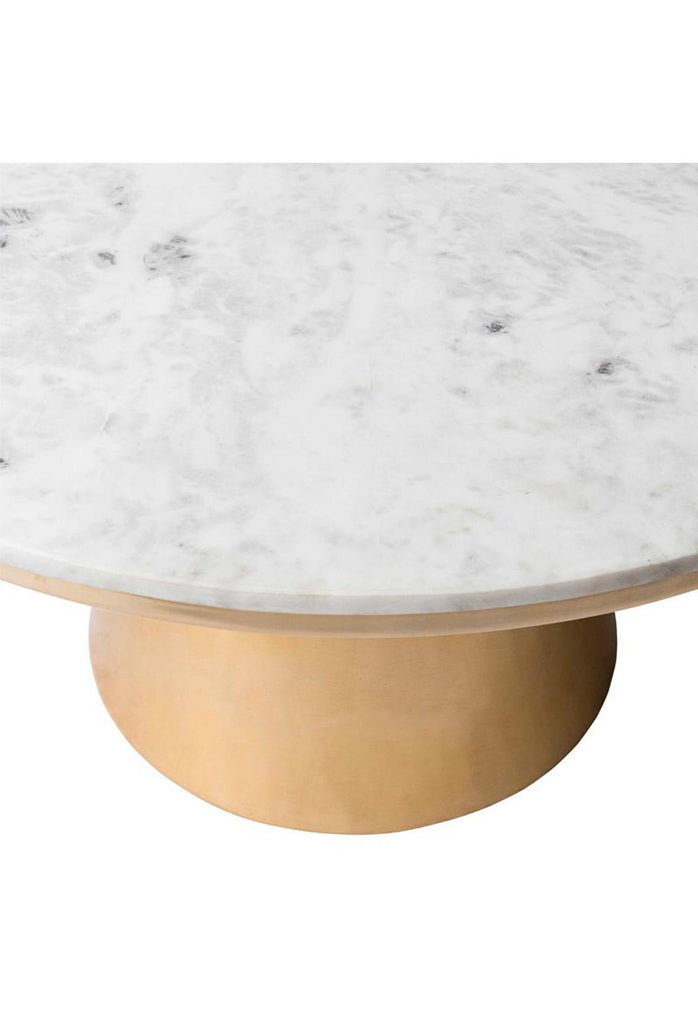 Large round coffee table with a brass drum base and a white marble top on white background