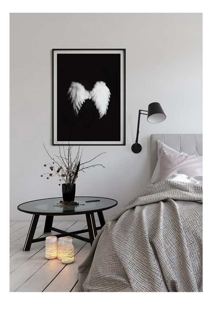 A fashion wall art with a pair of white swan wings on black background. 