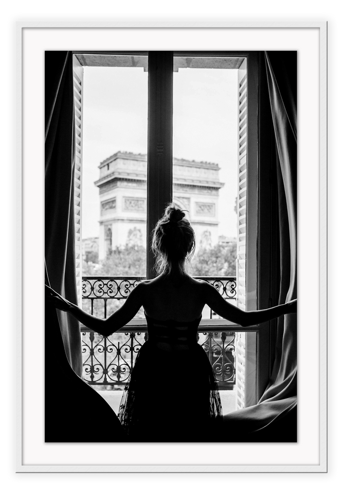 A black and white urban wall art with a girl looking out to the town from a vintage balcony in Paris. 