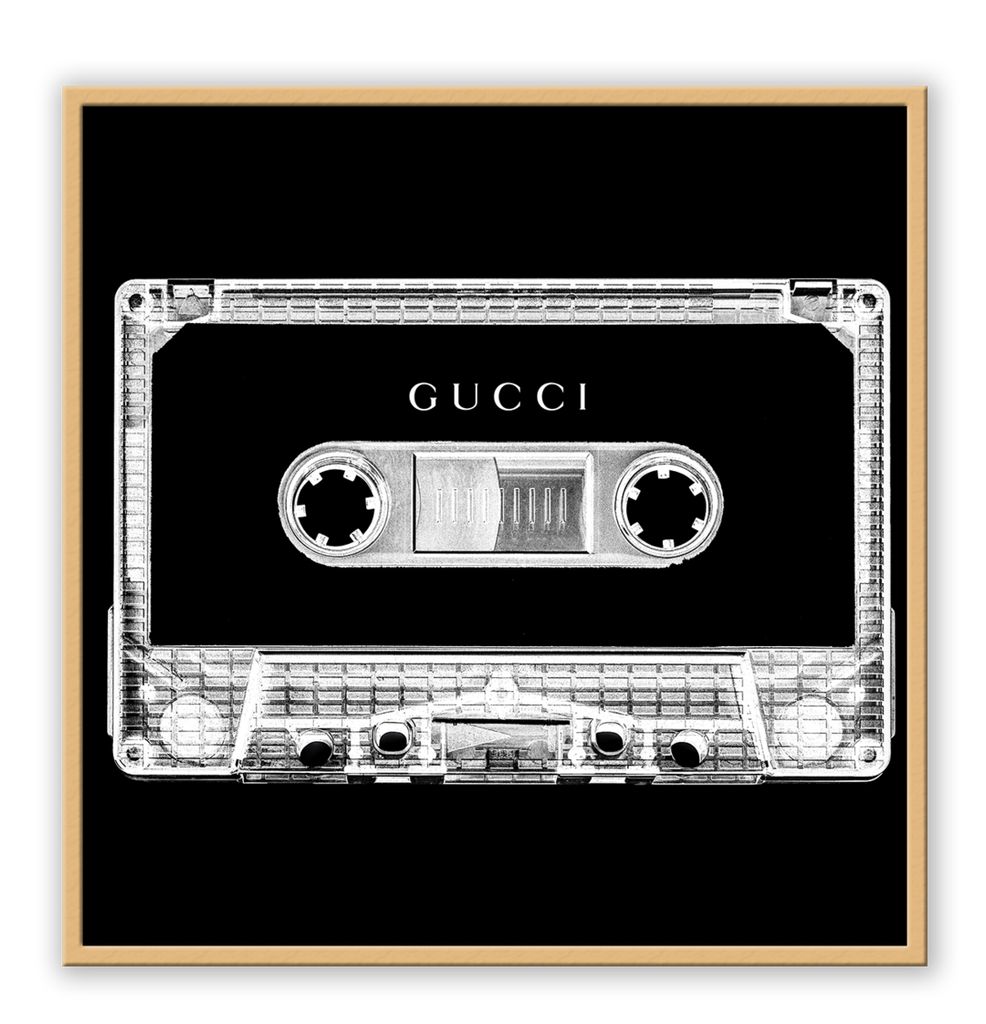 A vintage fashion wall art with Gucci fashion label on 80s 90s vintage cassette tape in fluro black and white inverted colour.