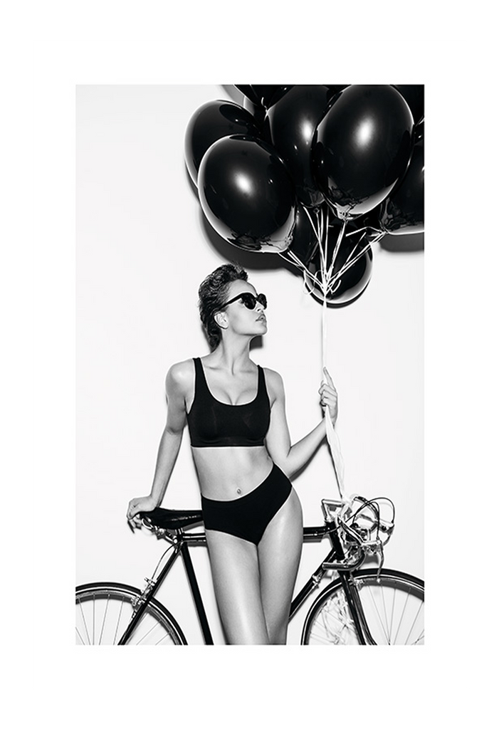 A fashion black and white wall art with a lady in lingerie holding balloons