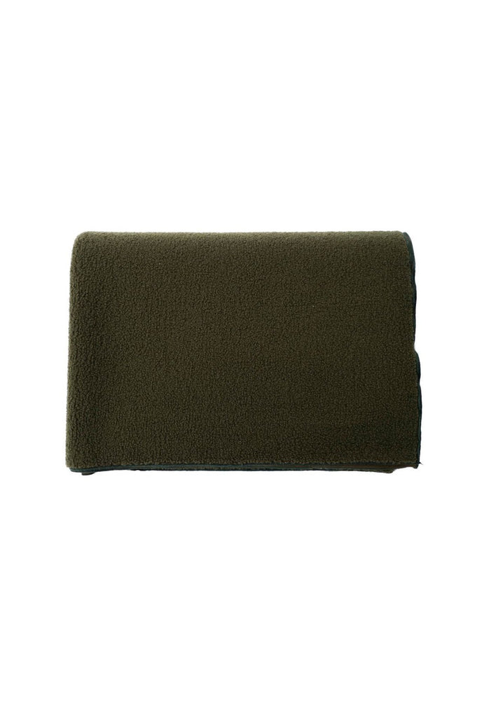 Soft plush blanket in dark olive green folded on a white background