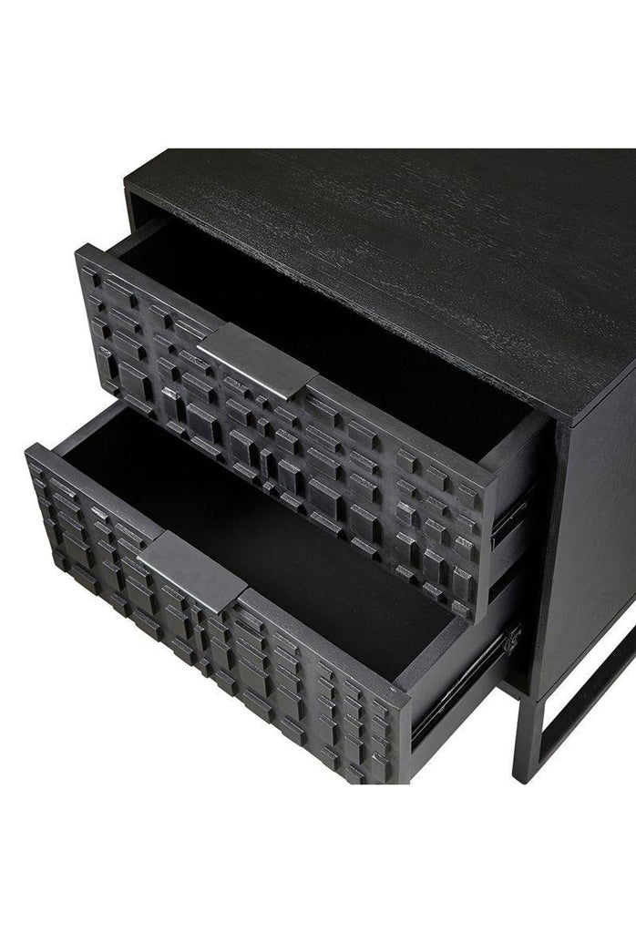 Black wooden cubic bedside table with two drawers featuring carved square shaped details on the front and slim black metal legs