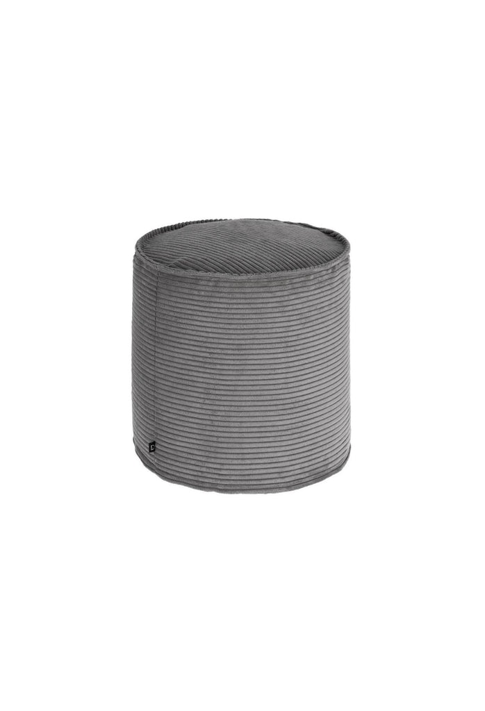 Small round cylinder shaped pouf fully upholstered in a soft grey corduroy fabric on a white background