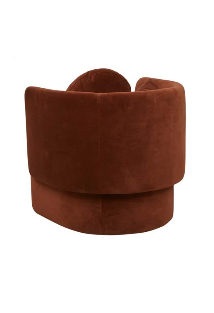 Fully upholstered tub-style armchair in cinnamon coloured velvet with matching cushions on a white background