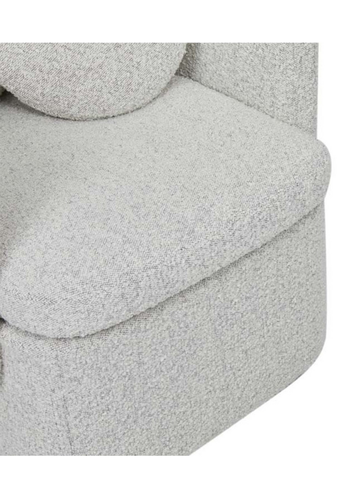Fully upholstered tub-style armchair in grey speckled boucle with matching cushions on a white background
