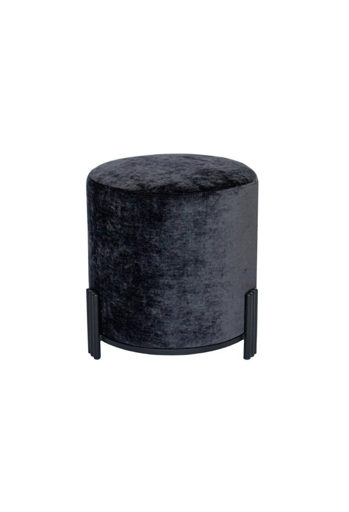 Round Ottoman upholstered in anthracite velvet with matte black metal base and three ribbed legs on white background