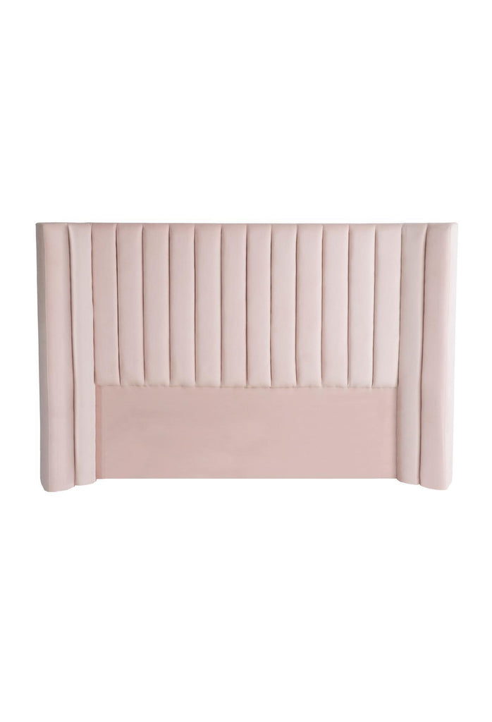 Plush Panelled Bedhead with Curved Sides Fully Upholstered in Blush Pink Velvet on a White Background