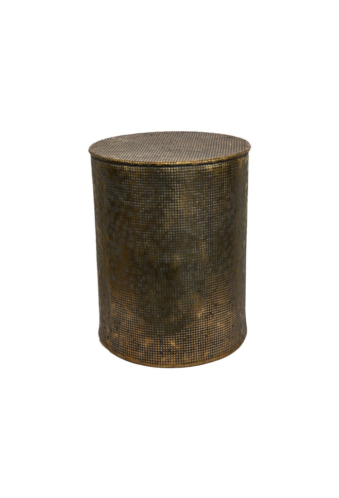 Solid cylinder shaped side table made of antique gold aluminium with hammered detailing and imperfections on a white background