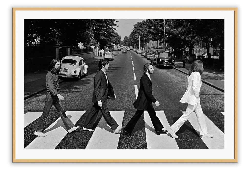 Black and white iconic photography print of the Beatles crossing abbey road in suits.