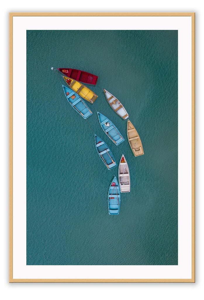Blue ocean boats on water colourful red yellow beige white in line