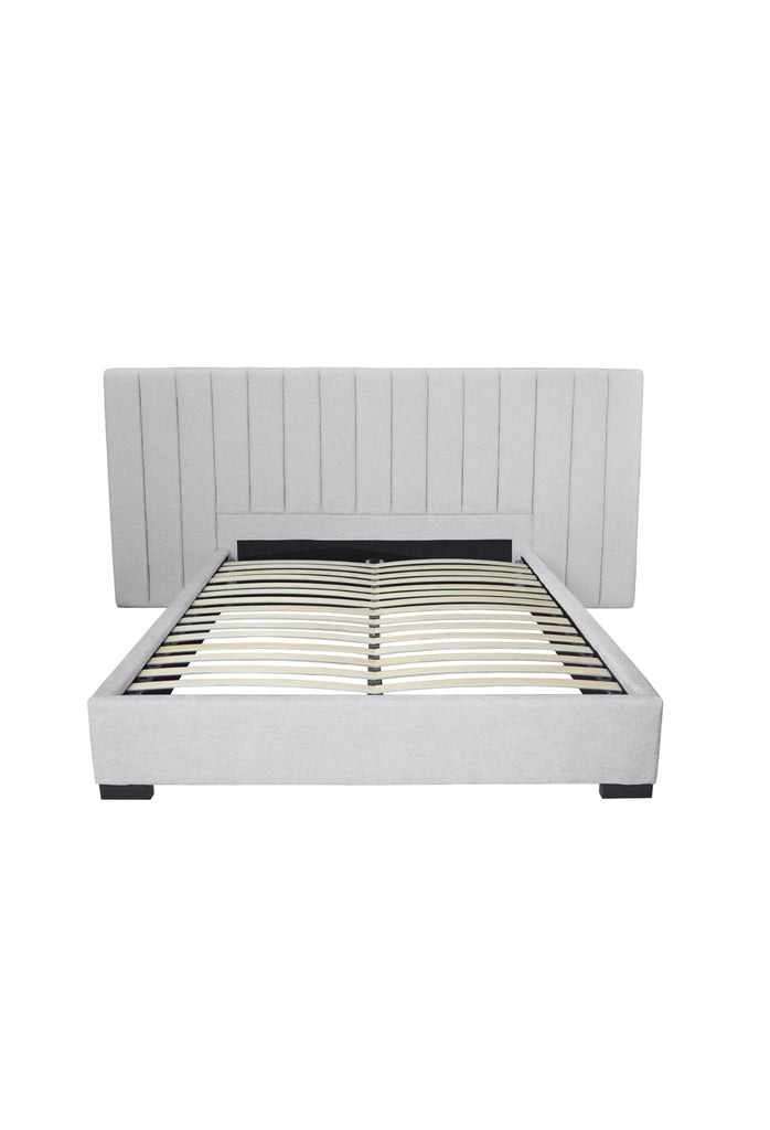 Luxurious panelled bed upholstered in a light grey textured fabric with a modern padded bedhead on a white background