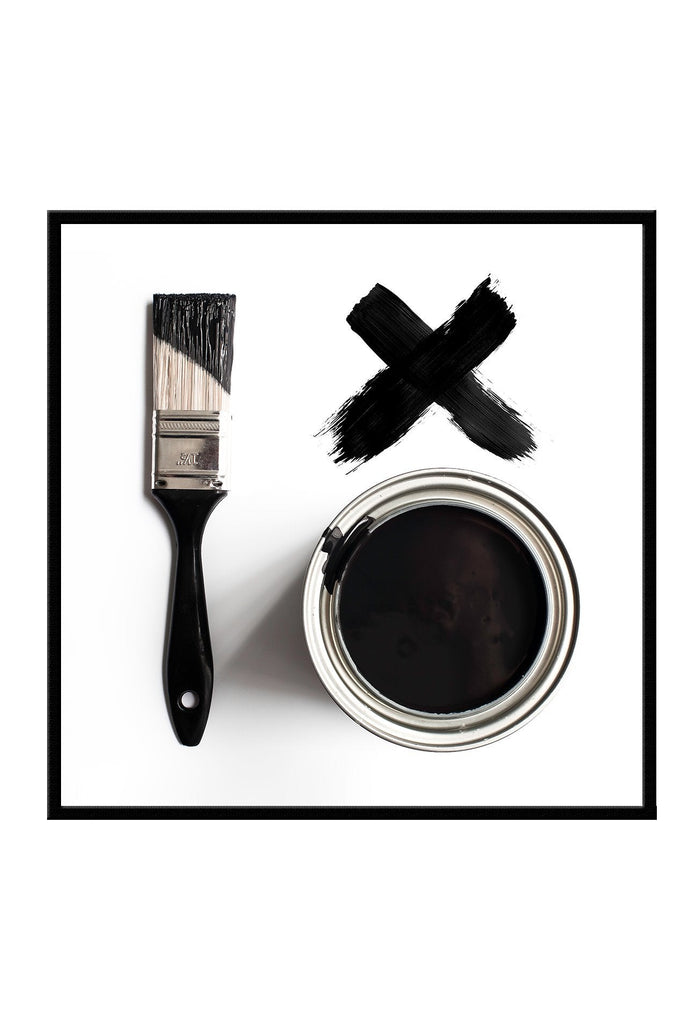 Scandi photography black and white image of white background, paint brush, can and black letter x. 