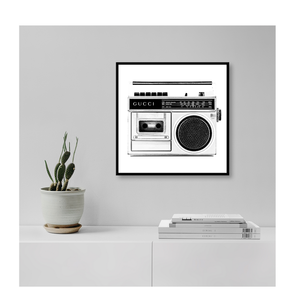 A vintage fashion wall art with Gucci fashion label on 80s 90s vintage recorder in black and white. 
