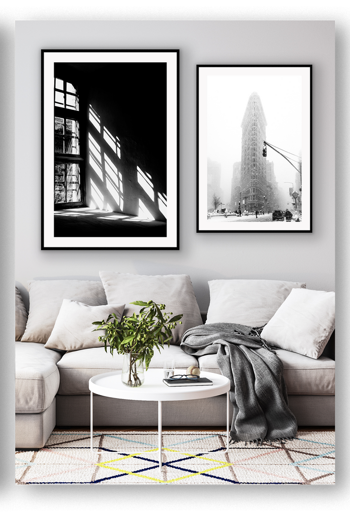 A black and white wall art with sunlight penetrating through big windows casting window shadows and creating high contrast.  