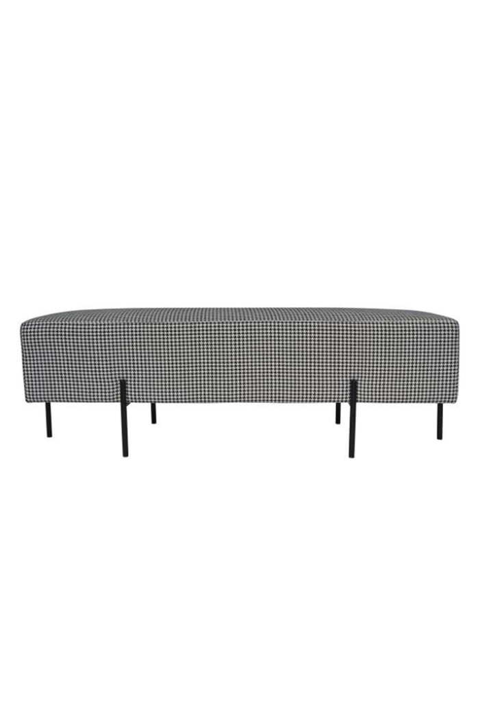 Minimalistic Bench Ottoman Upholstered in a Houndstooth Patterned Fabric with Six Thin Black Steel Legs on a White Background