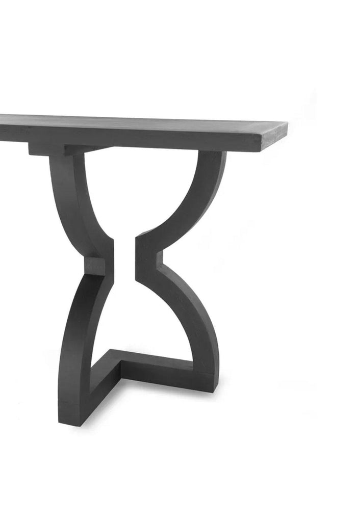 Black oak console table with solid rectangular table top and chunky curvy shaped legs with sharp edges on the base