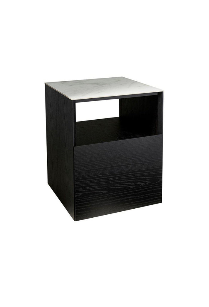 Black wooden bedside table in clean geometric shape with one deep drawer and middle compartment and a white ceramic marble top