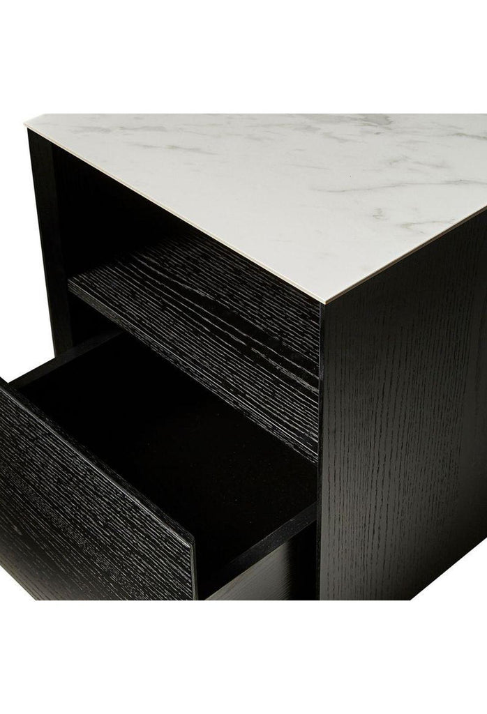 Black wooden bedside table in clean geometric shape with one deep drawer and middle compartment and a white ceramic marble top