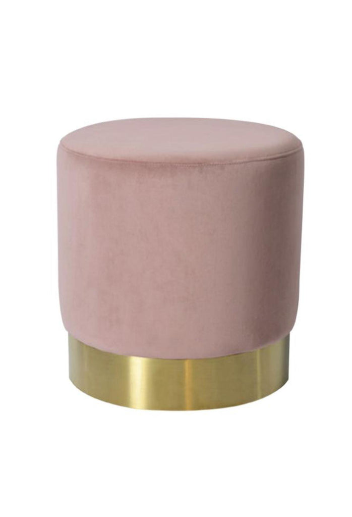 Small solid round ottoman fully upholstered in a light blush pink coloured velvet with a brushed gold base on a white background