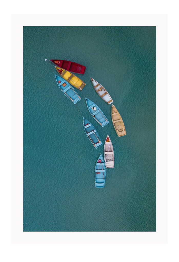 Blue ocean boats on water colourful red yellow beige white in line